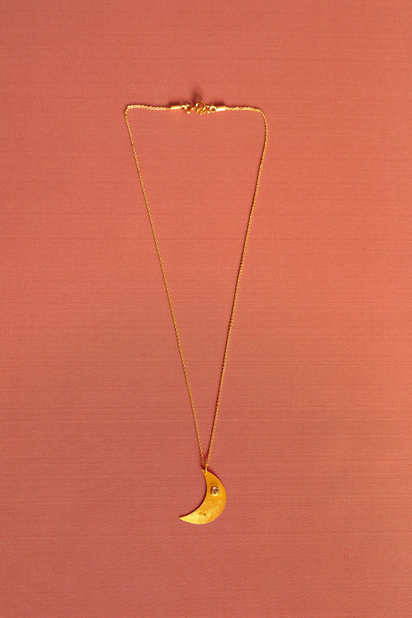 Aku gold pendant