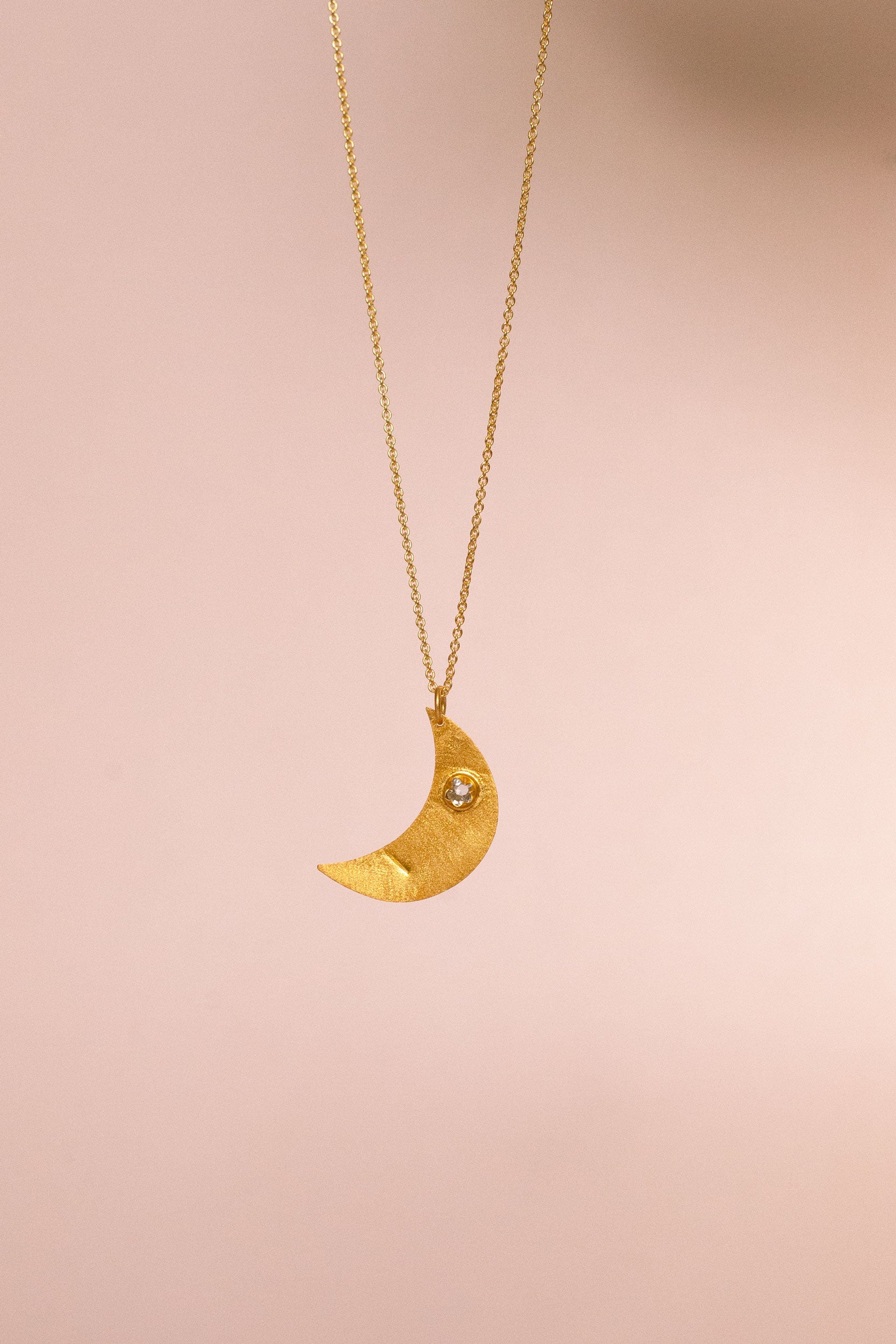 Aku gold pendant