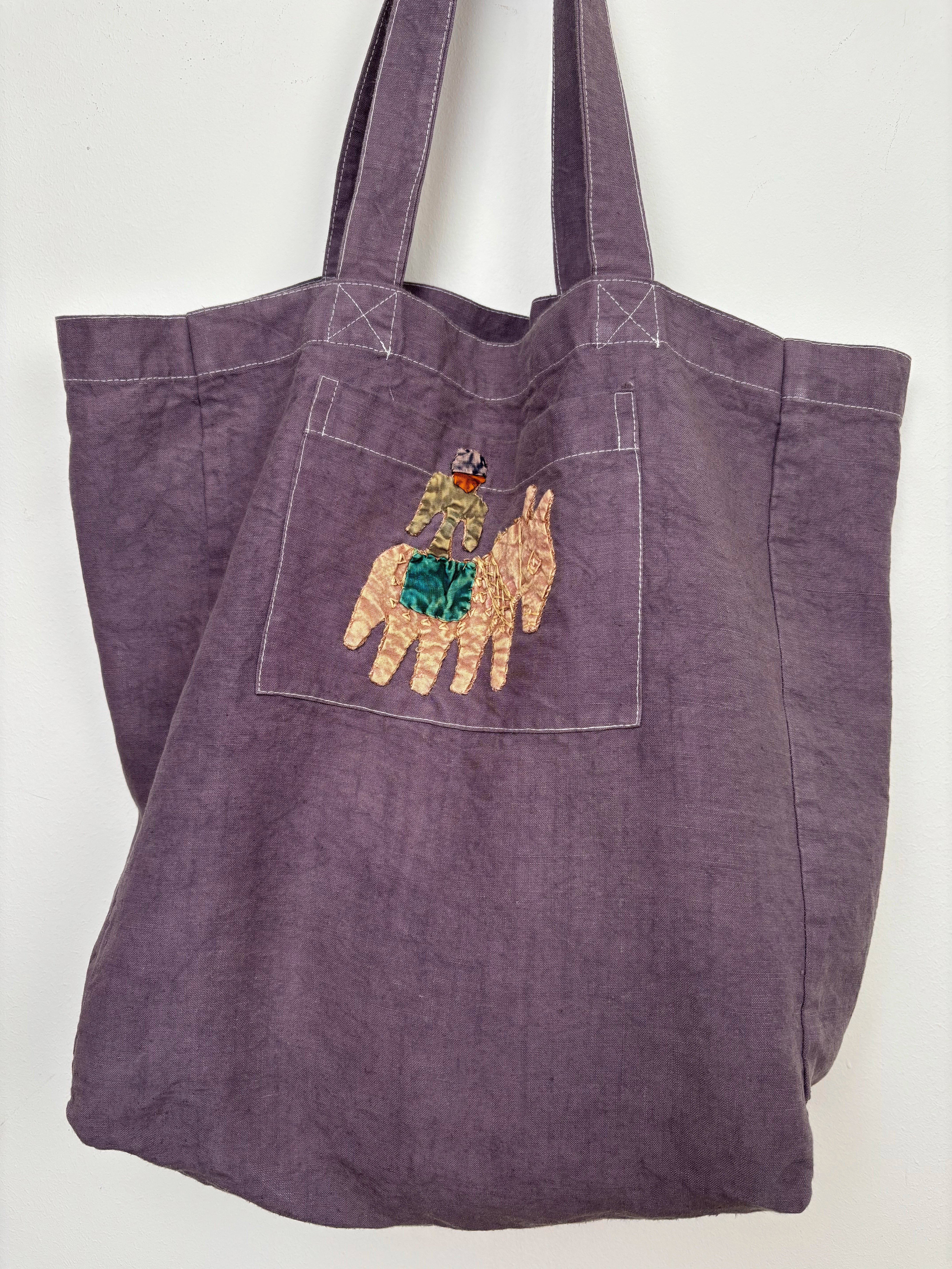 Yellow horse in a lilac dyed bag