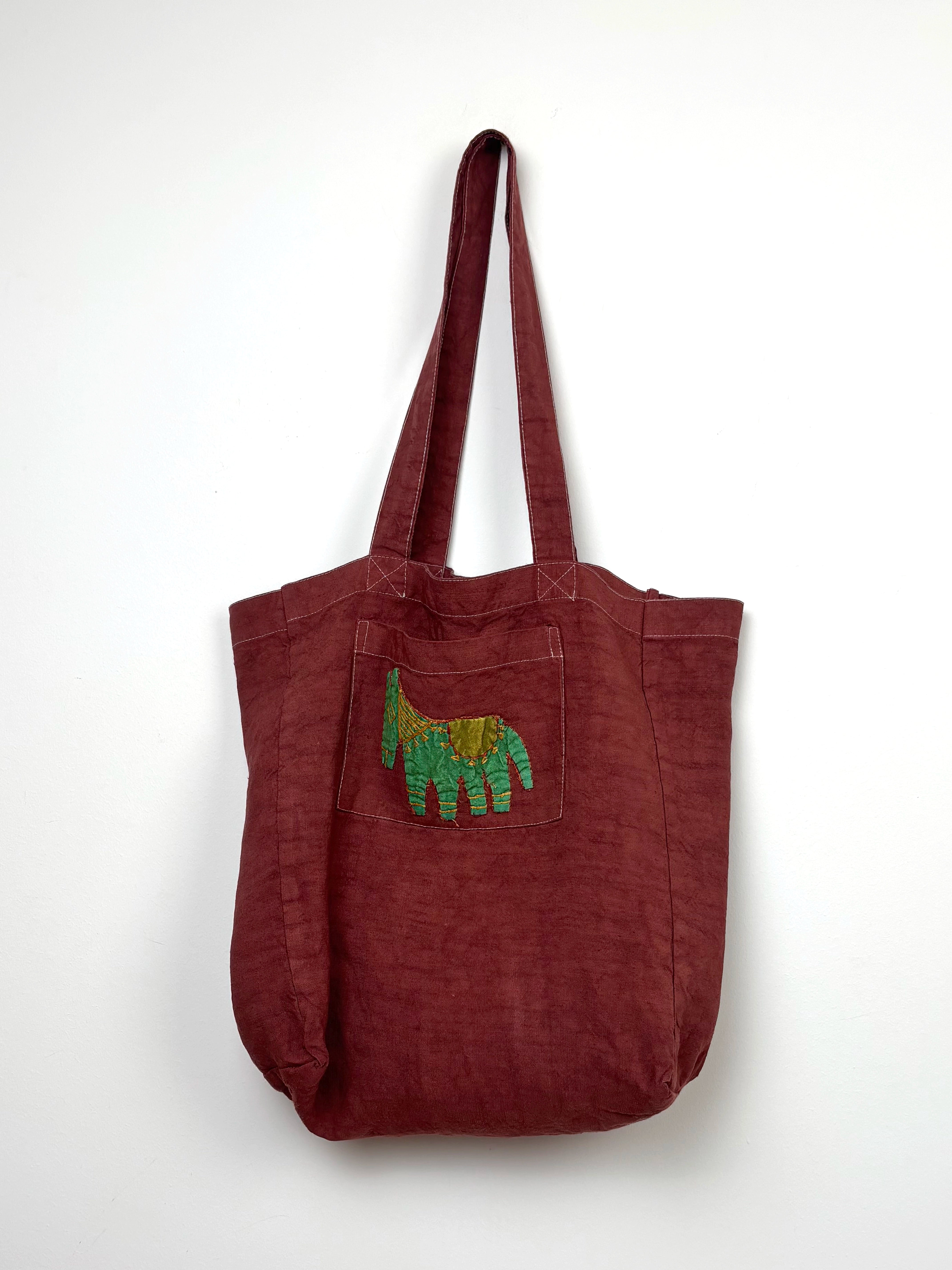 Green horse in a terracota dyed bag
