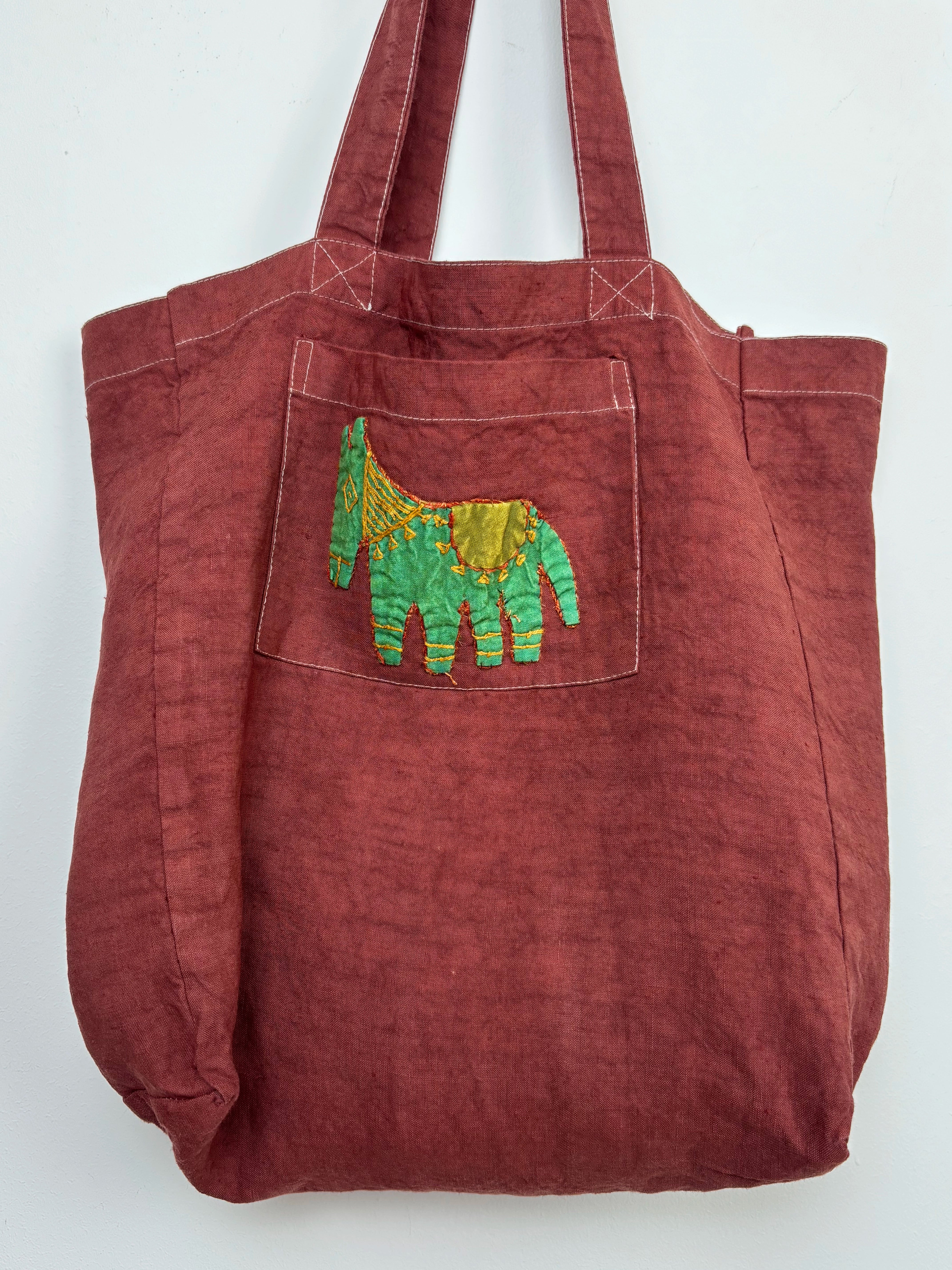 Green horse in a terracota dyed bag