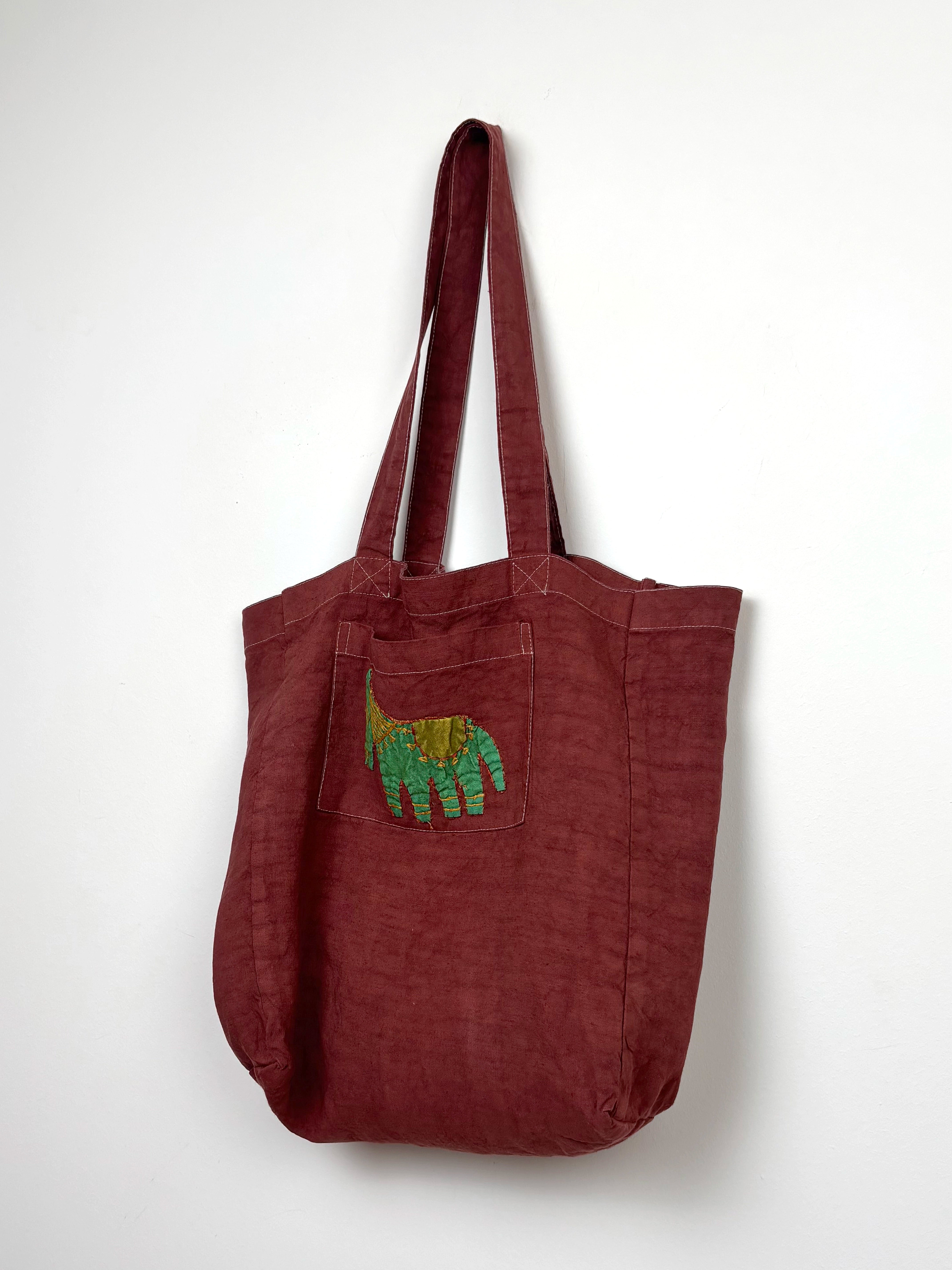 Green horse in a terracota dyed bag